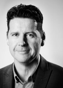 Black and white portrait of WIRED magazine editor Greg Williams