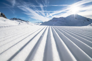 Close up shot of snow on a ski run