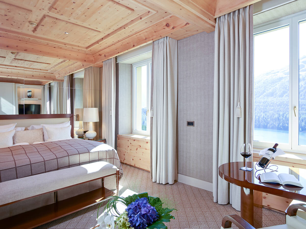 A luxury ski hotel bedroom with natural colour palette and wooden roof