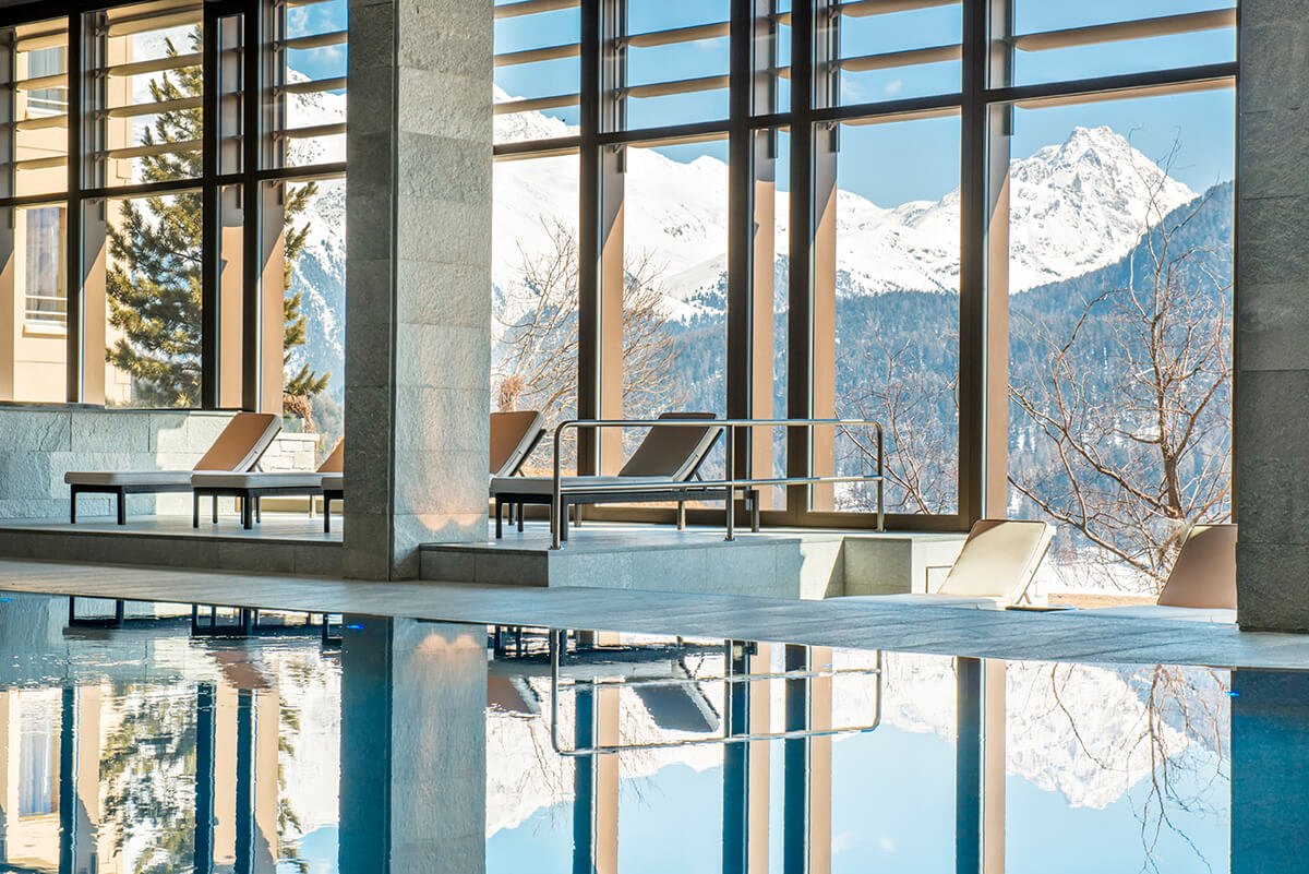 Alpine luxury spa with views of snow topped mountains and an indoor pool