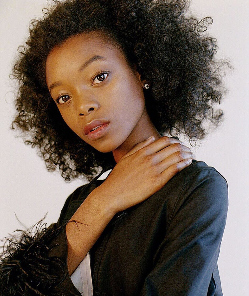 Portrait of a Afro-America model positing in natural make-up wearing a black jackt