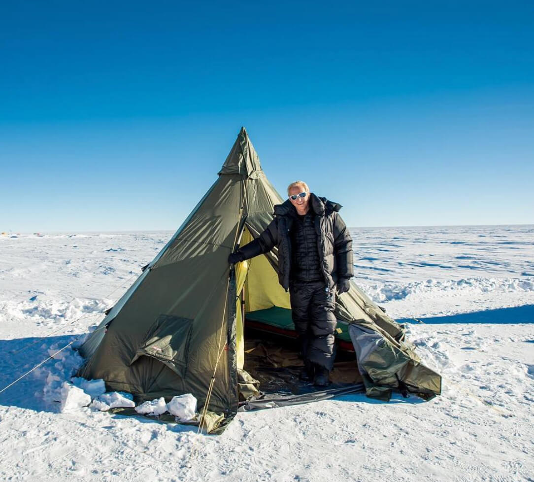 Businessman and traveller Geoffrey Kent poses in front of tent in the South Pole