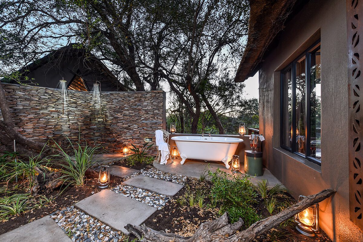 An alfresco bath tub surrounded by candles