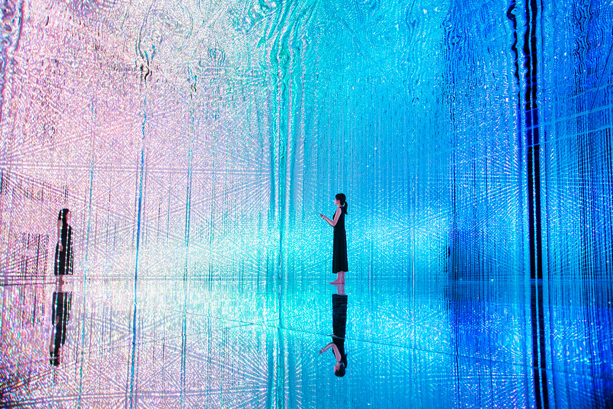 Immersive digital art installation with coloured lights surrounding a room