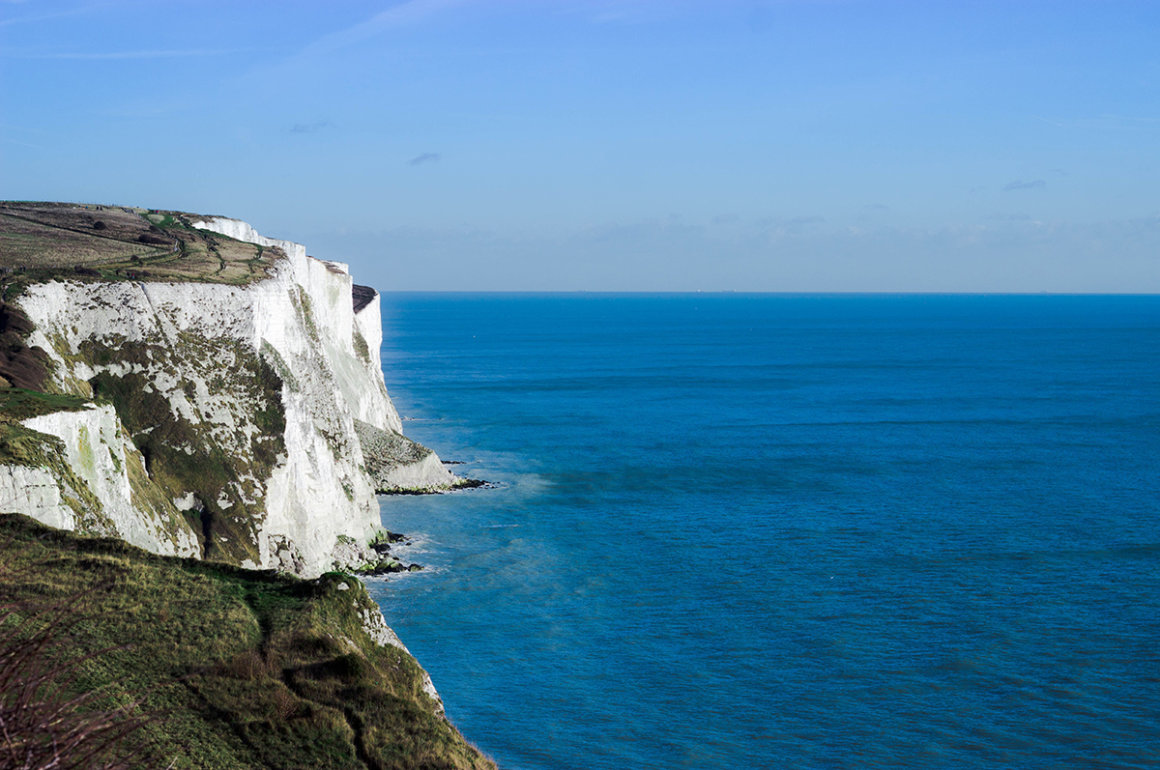 White cliffs of dover with the channel stretching into a blue horizon