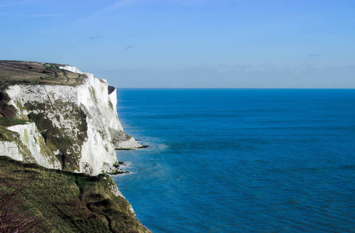White cliffs of dover with the channel stretching into a blue horizon