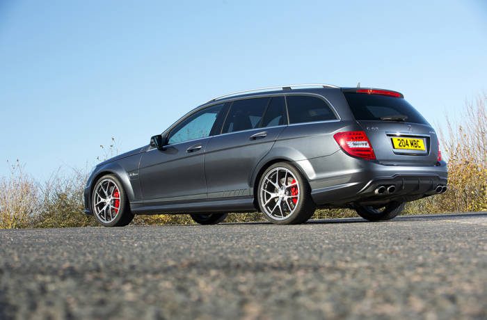 Mercedes-Benz C63 AMG silver car pictured against blue sky