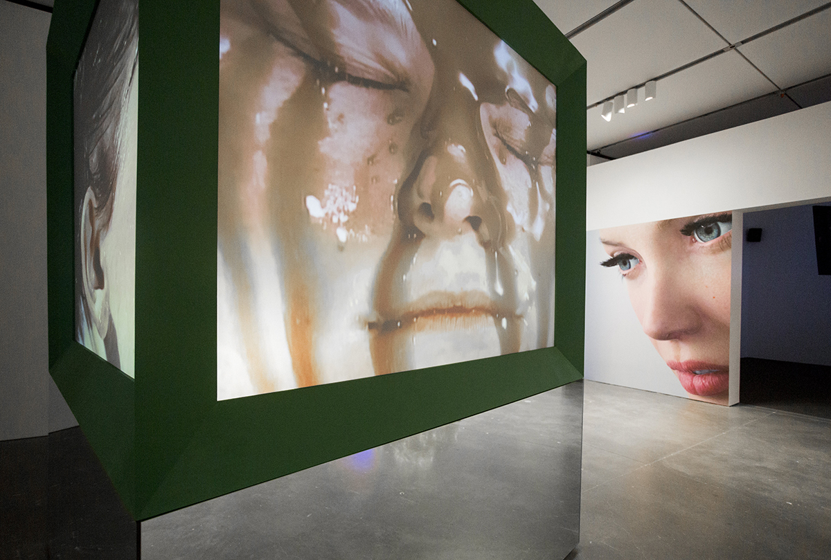 Installation shot of a gallery exhibition showing digital videos