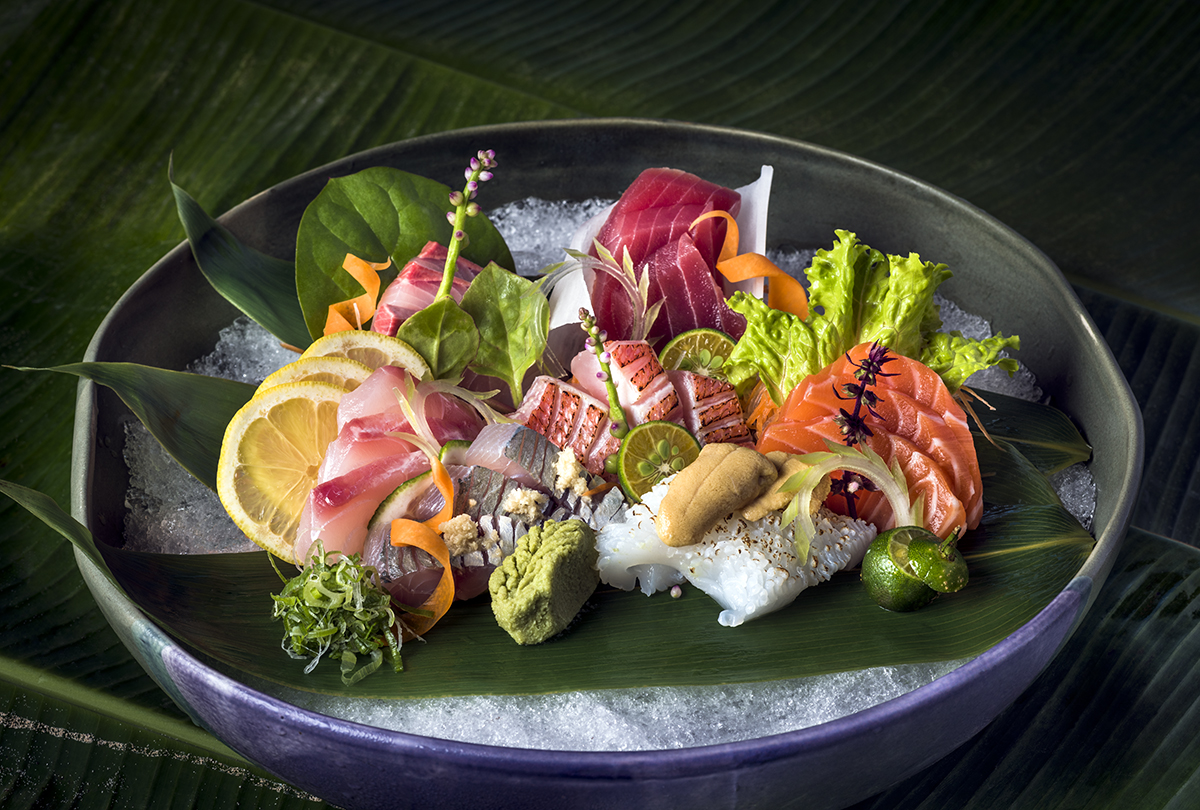 Sushi and sashimi arranged on a bowl of ice