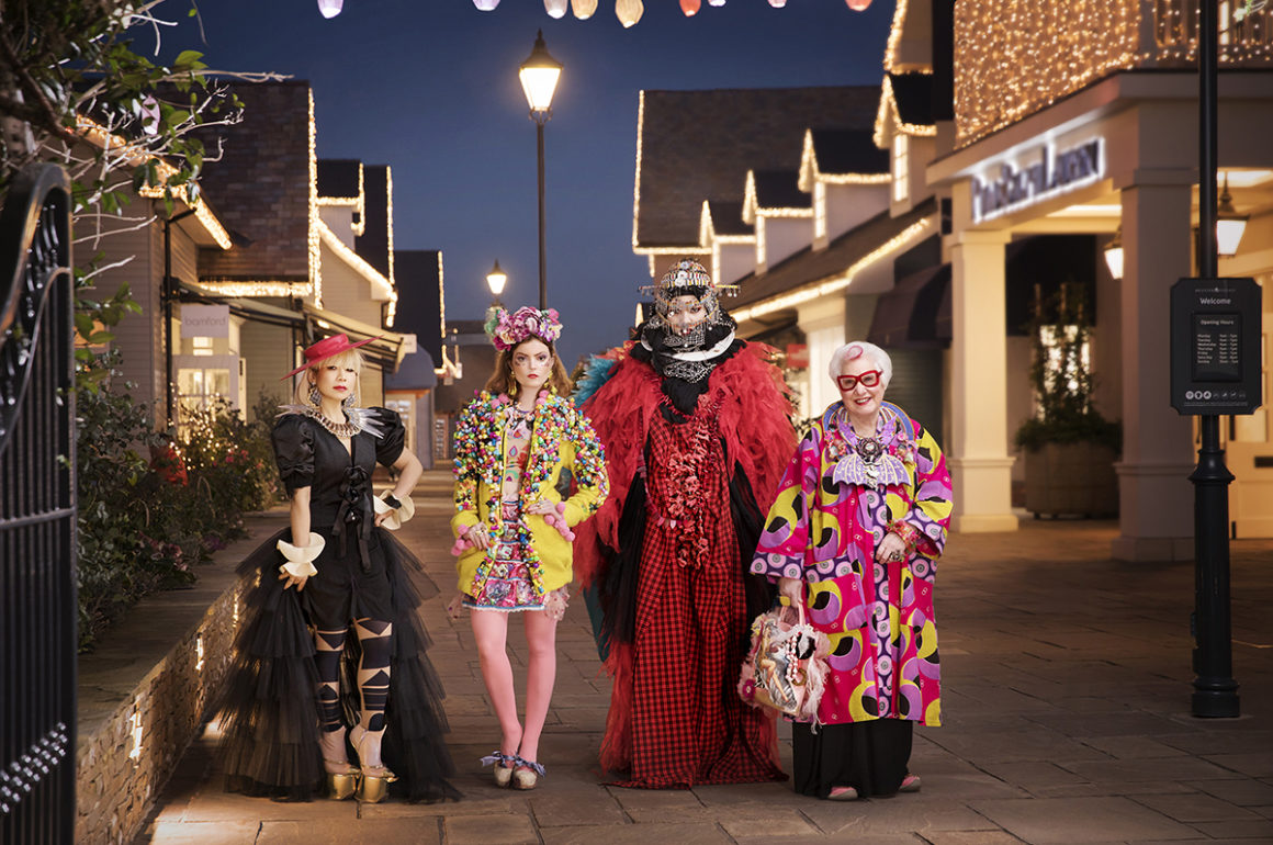 Eccentrically dressed artists pose in Bicester Village luxury retail destination
