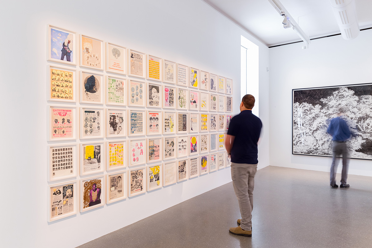 Visitor stands in front of gallery exhibition 