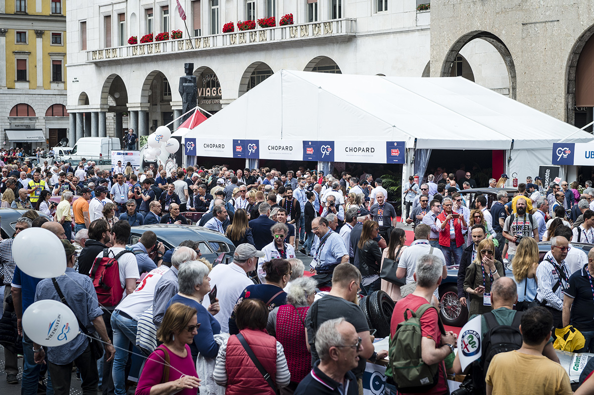 Crowds of people gather in a square for the start of Mille Miglia