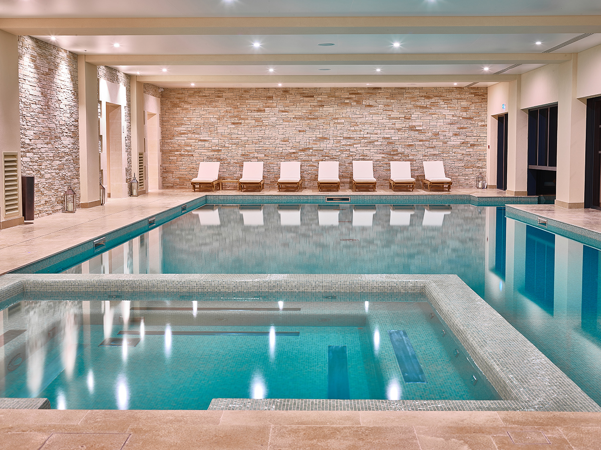 Luxury spa swimming pool with sun loungers