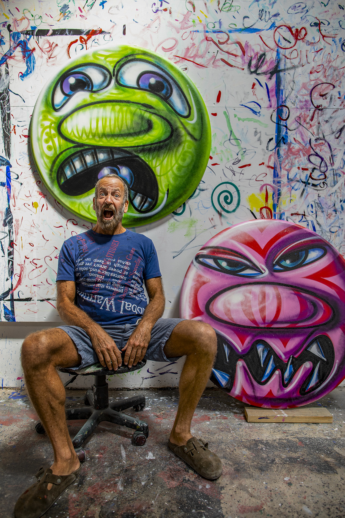 Painter Kenny Scharf pictured in front of his artwork