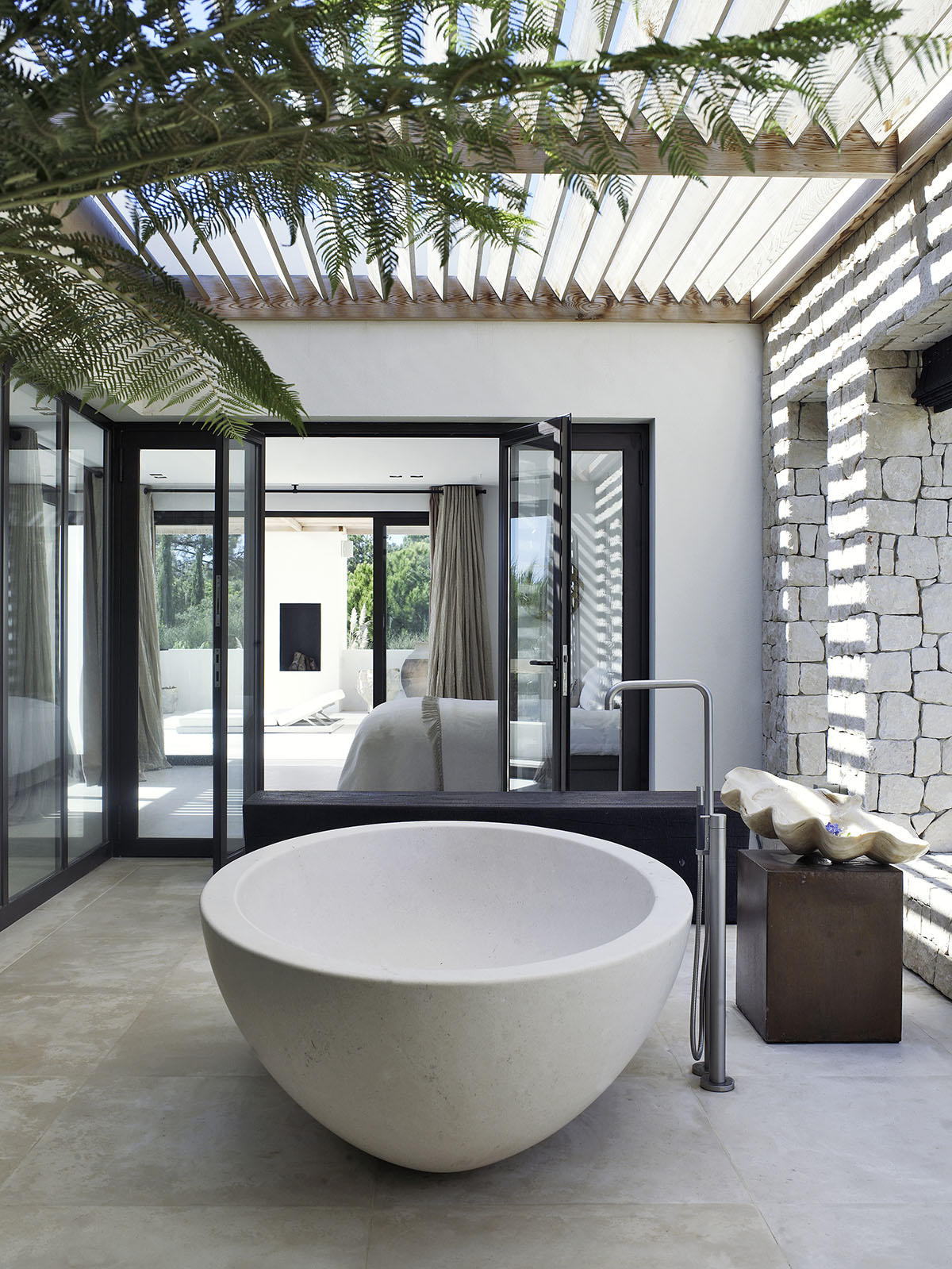 Luxury interior of a bedroom with an outdoor bathtub