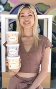 CEO of Mylk Labs holding a tower of three pots