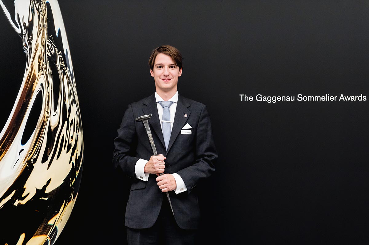 Young man standing in front of a black wall at the Gaggenau sommelier awards