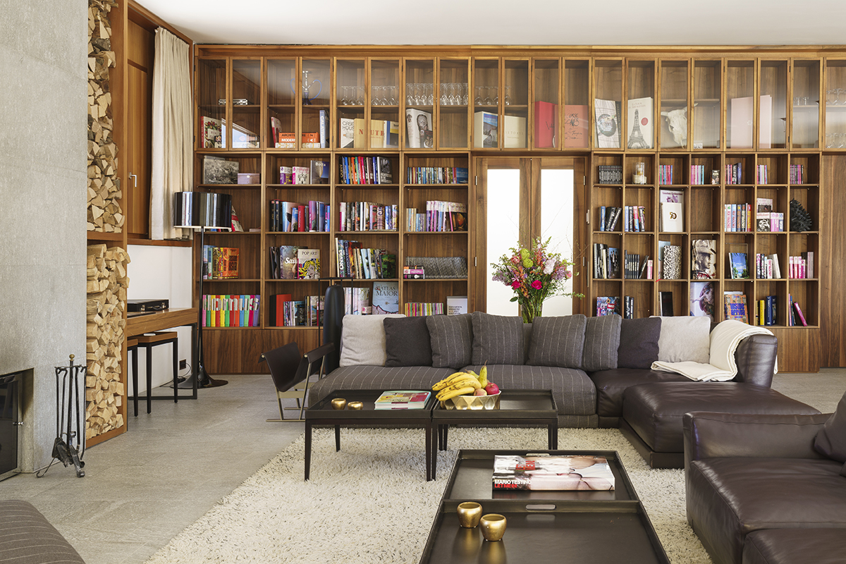 Luxury interiors of a sitting room with a wall of book shelves