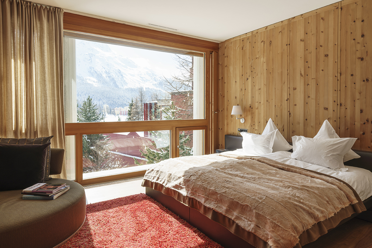 luxury interiors of a double bedroom with wooden chalet walls