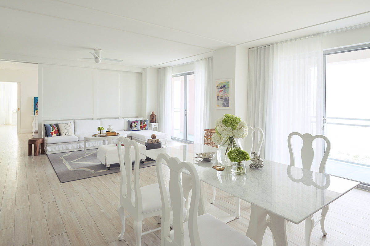 Open plan living area decorated in white contemporary furnishings