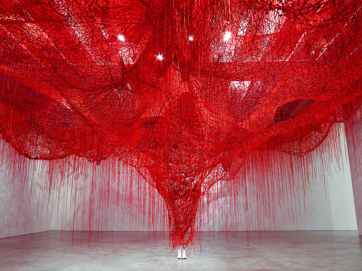 Large scale sculptural installation of red threads