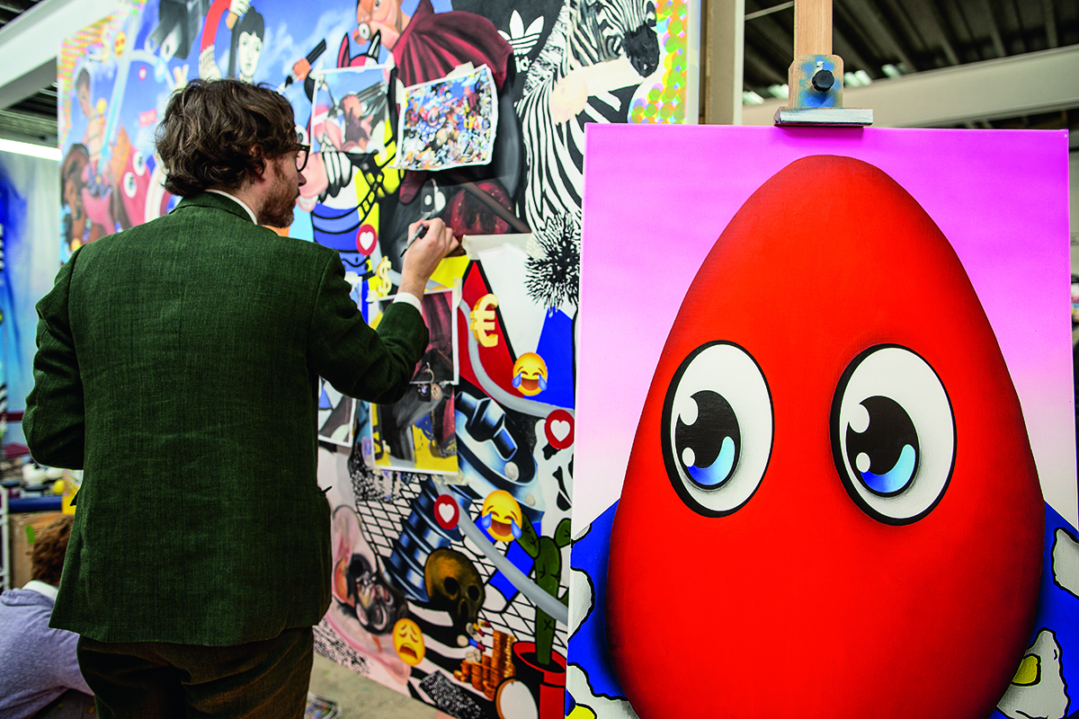 Artist Philip Colbert at work on a painting in his studio