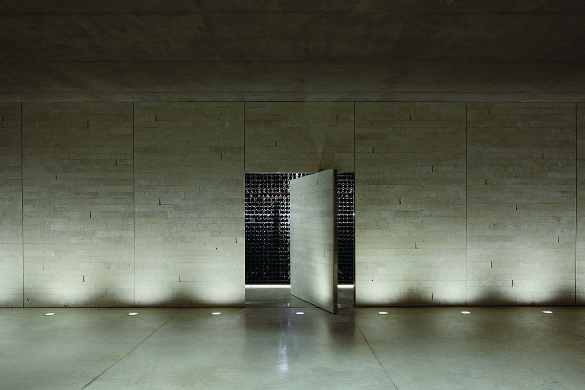 Contemporary clean architecture of a wall and door leading into a wine cellar