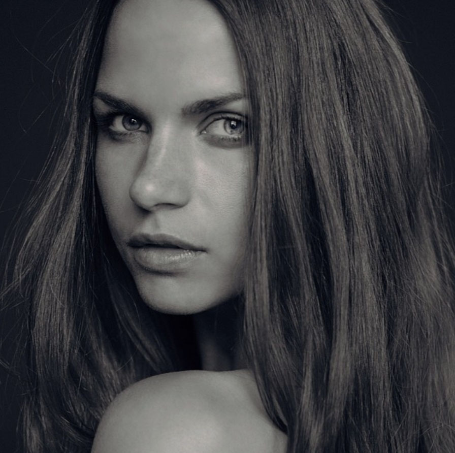 Monochrome close up portrait of a woman with dark brown hair