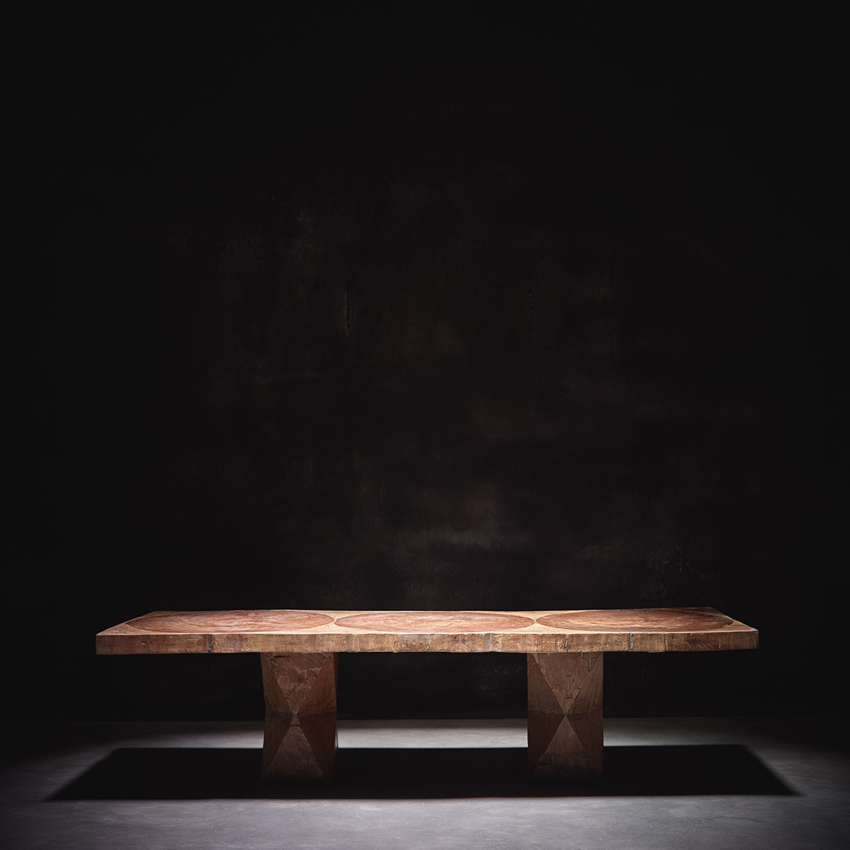 Low coffee table photographed under spotlight in a dark room