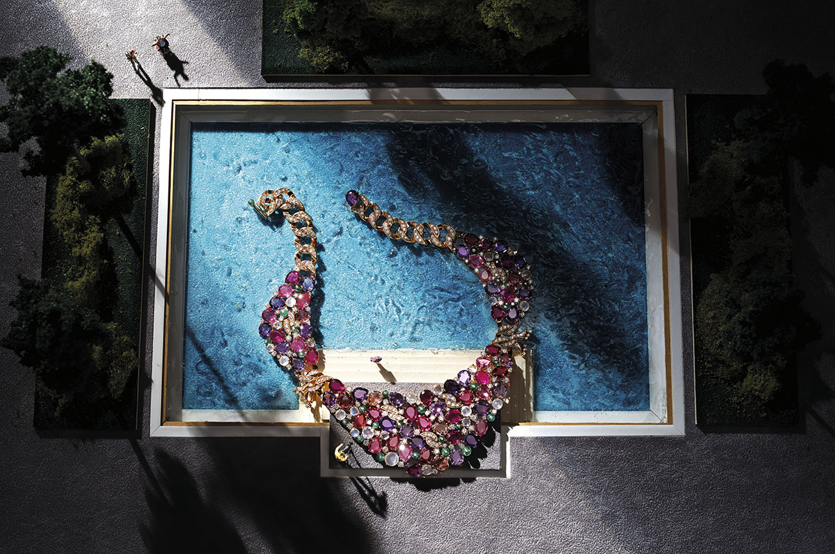 Sparkly necklace with multiple jewels pictured in the model of a swimming pool