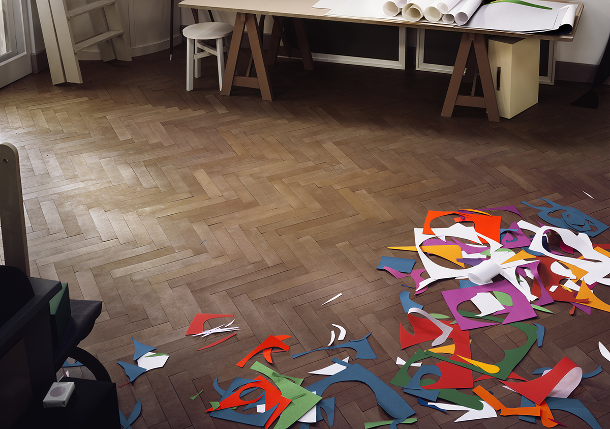 Coloured paper cutouts scattered on a wooden floor