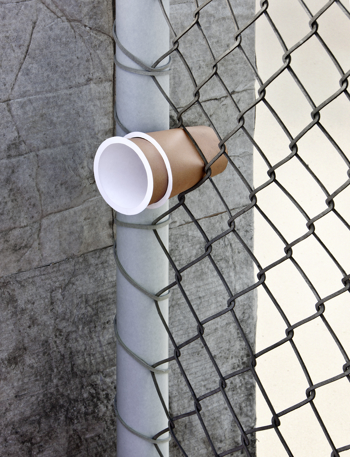 Coffee cup wedged in a wire fence