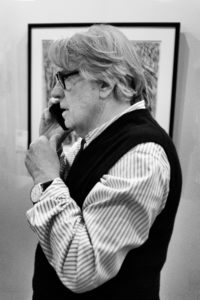 Portrait photograph of the profile of a man on the phone