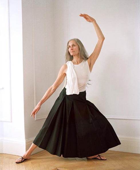 Elderly woman poses in a ballerina posture