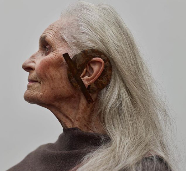 Side profile portrait of an elderly woman wearing a statement earring 