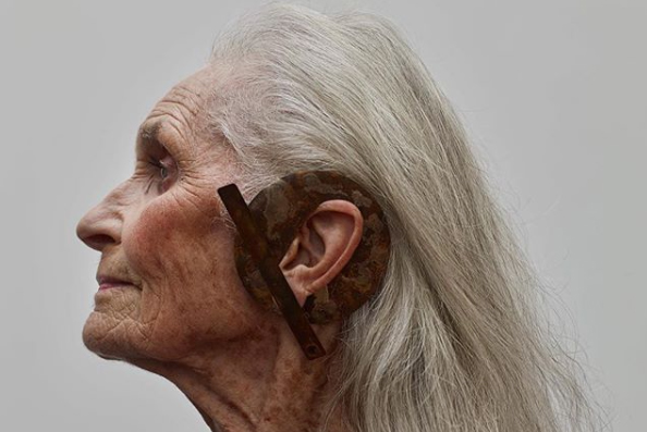 Side profile portrait of an elderly woman wearing a statement earring