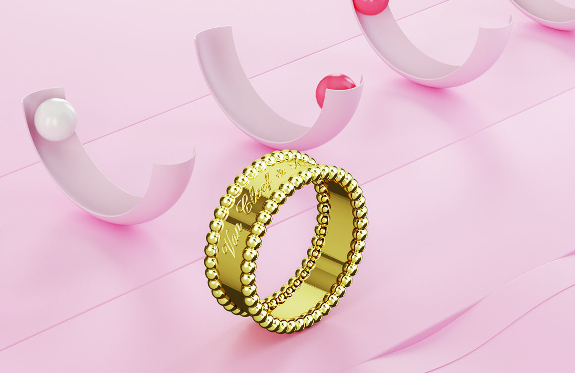A gold ring on a pink surface with half pink circles in the background