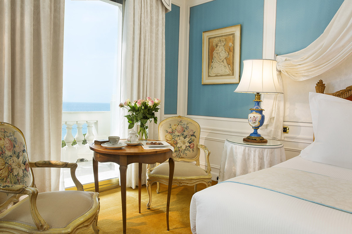 Luxurious hotel suite with a balcony and views of the sea