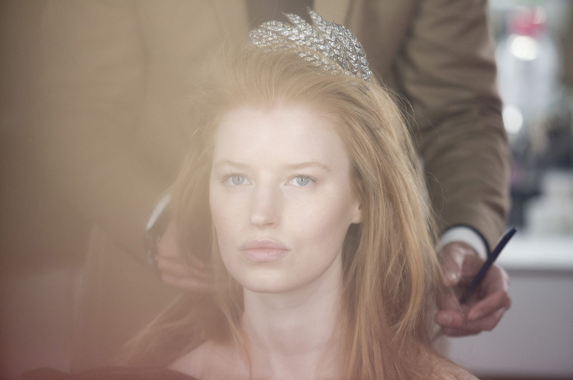 Backstage image of a model wearing a tiara