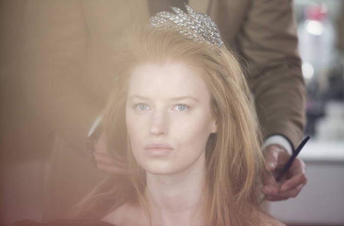 Backstage image of a model wearing a tiara