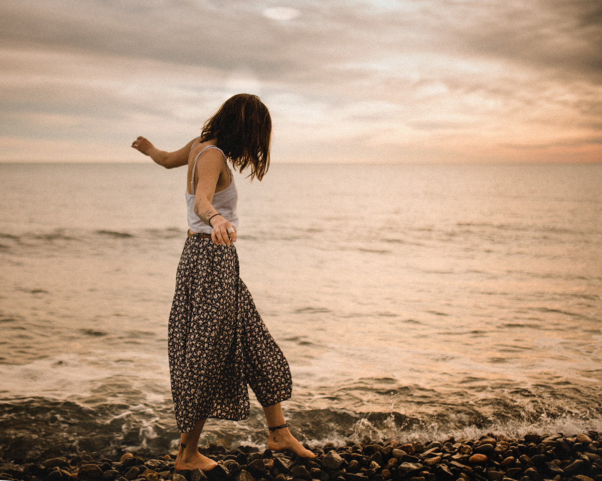 Woman walking bare foot along the beach