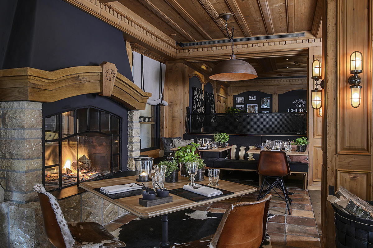 luxury rustic interiors of an alpine restaurant with an open fire