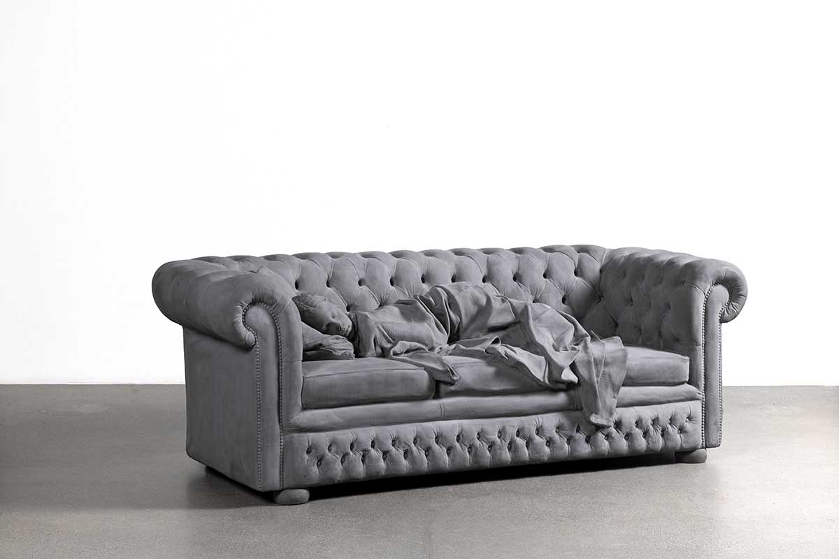 Sculpture of a girl asleep on a sofa