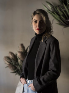 Portait of a young woman wearing a blazer and red lipstick