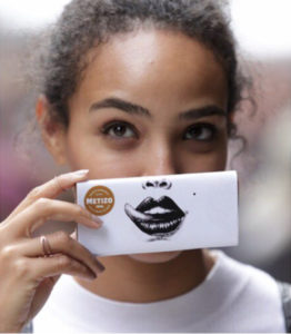 Girl holding a bar of chocolate over her lips