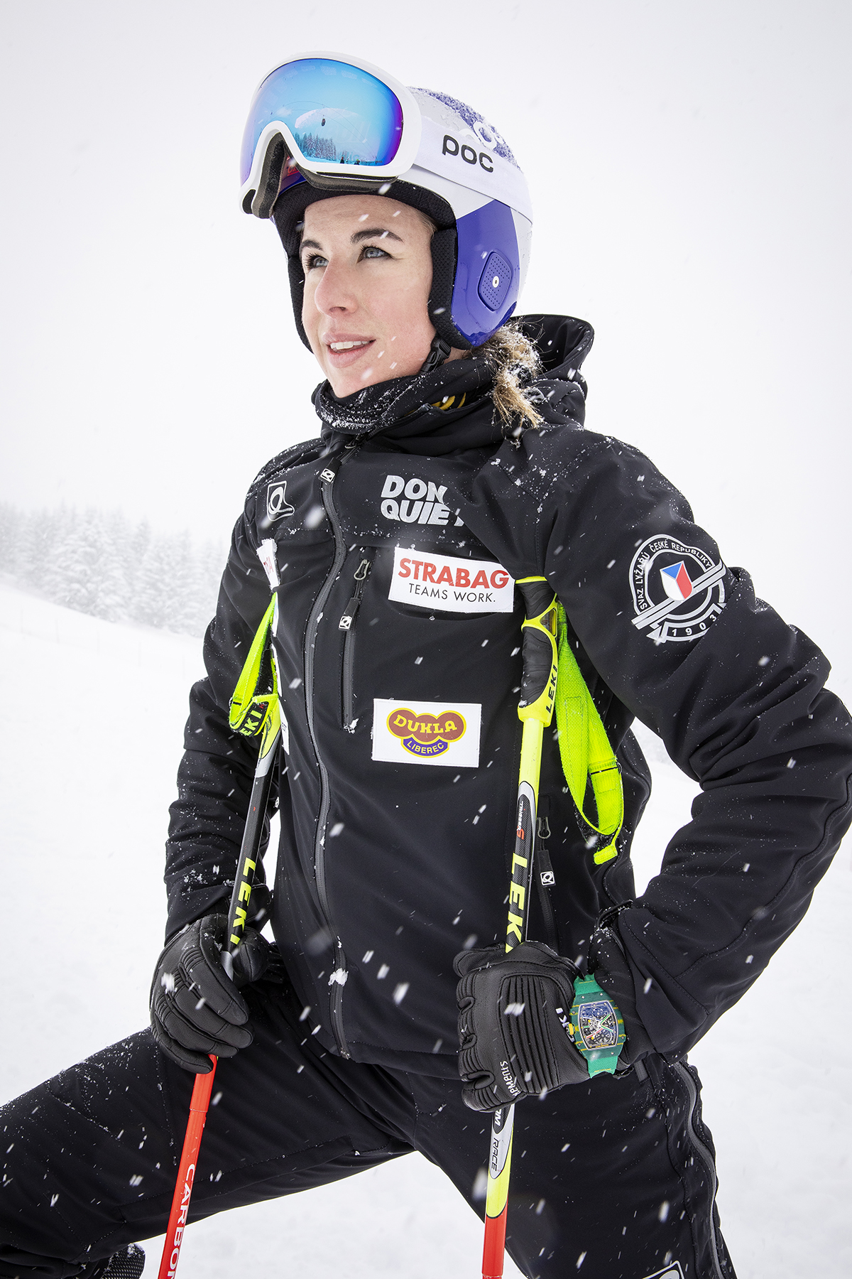 Woman in ski gear and helmet on ski slopes