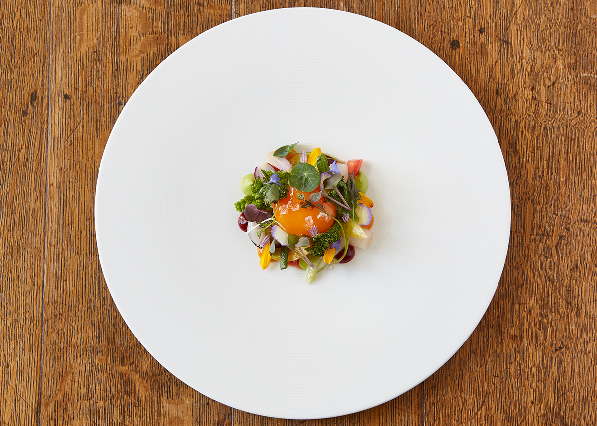 Luxury fine dining dish with flowers and egg yolk