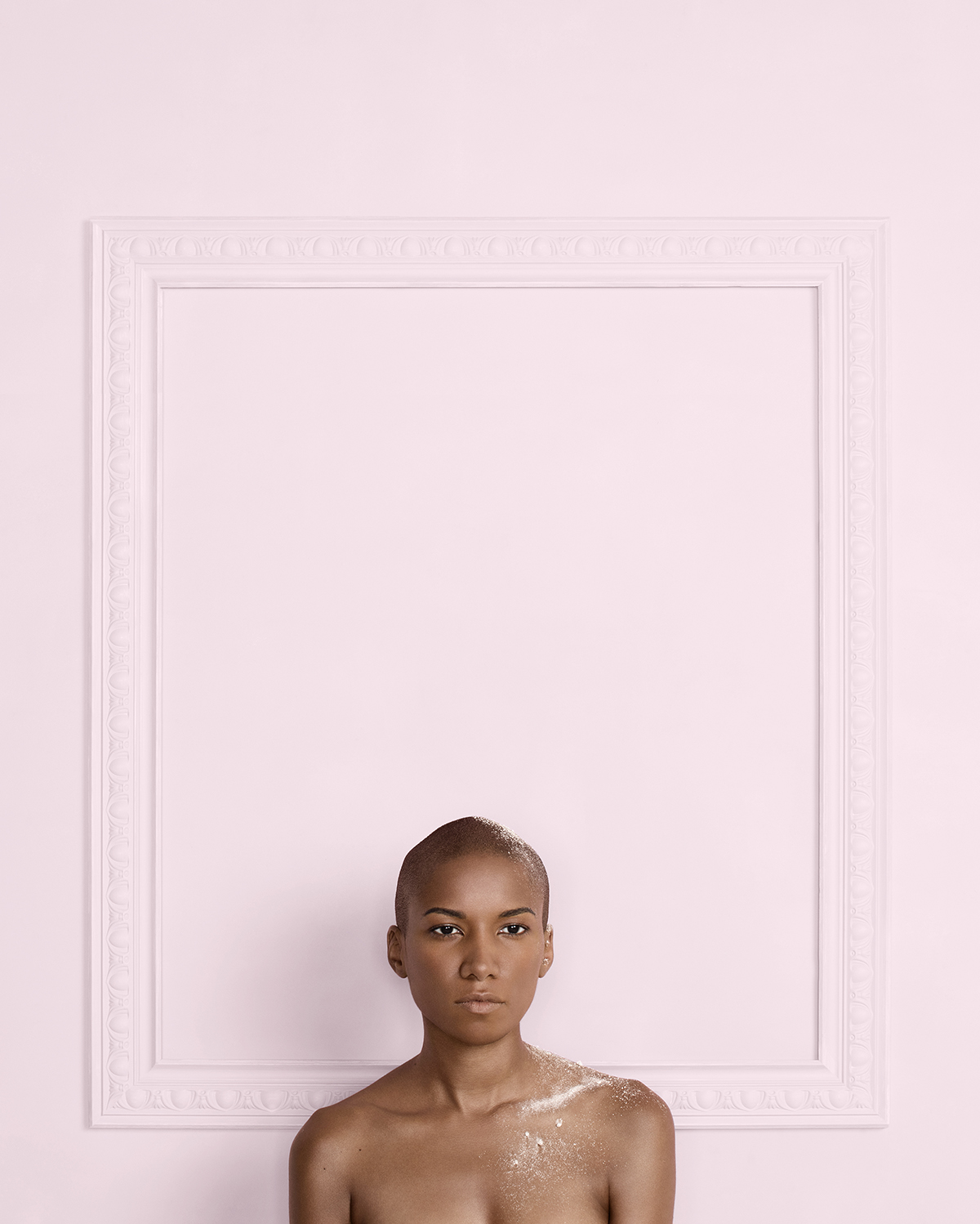 Portrait of a woman standing in front of a pink wall