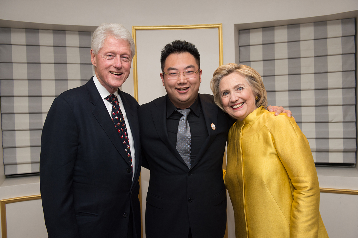 President Bill Clinton with Hillary and another man