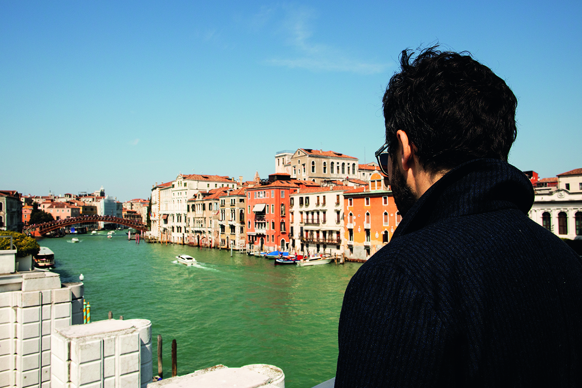 A man standing above Grand Canal venice